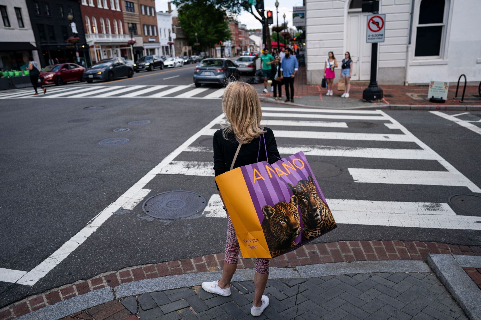 A shopper carries a bag in the Georgetown neighborhood of Washington, DC. Photographer: Al Drago/Bloomberg