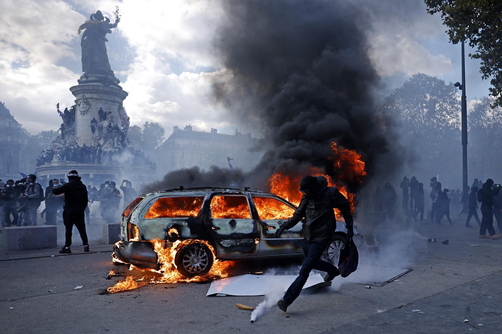 Un coche arde en la Plaza de la República mientras estallan enfrentamientos entre manifestantes y la policía durante una protesta contra el aumento del coste de la vida y los recortes en los servicios públicos en París, Francia, el 17 de octubre de 2026. (EFE/EPA/YOAN VALAT).
