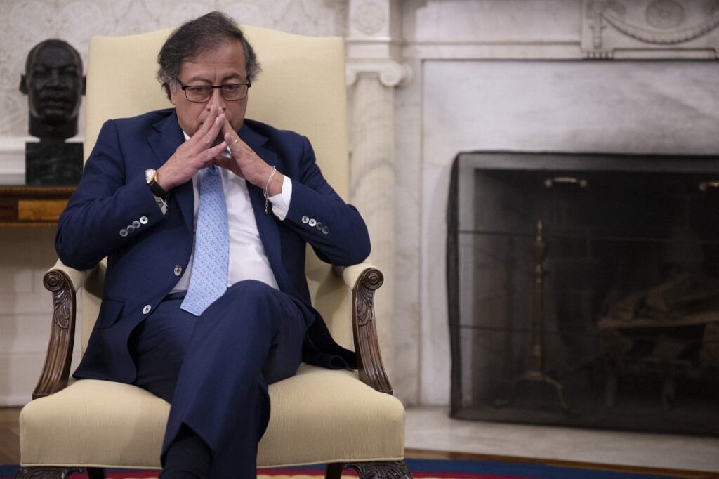 (FILES) Colombian President Gustavo Petro listens during a meeting with US President Joe Biden in the Oval Office of the White House in Washington, DC, on April 20, 2023. US President Donald Trump on January 26, 2025, ordered sweeping tariffs and sanctions against Colombia in retaliation for its refusal to accept deportation flights, as Bogota responded in kind with a 25 percent levy on US goods. (Photo by Jim WATSON / AFP)