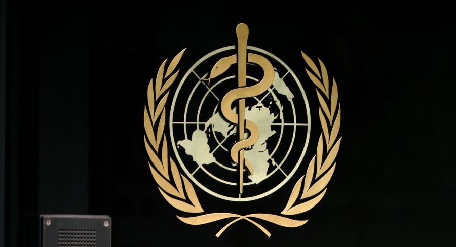 A photo taken in the late hours of August 17, 2020 shows a sign of the World Health Organization (WHO) at the entrance of their headquarters in Geneva amid the COVID-19 outbreak, caused by the novel coronavirus. (Photo by Fabrice COFFRINI / AFP)