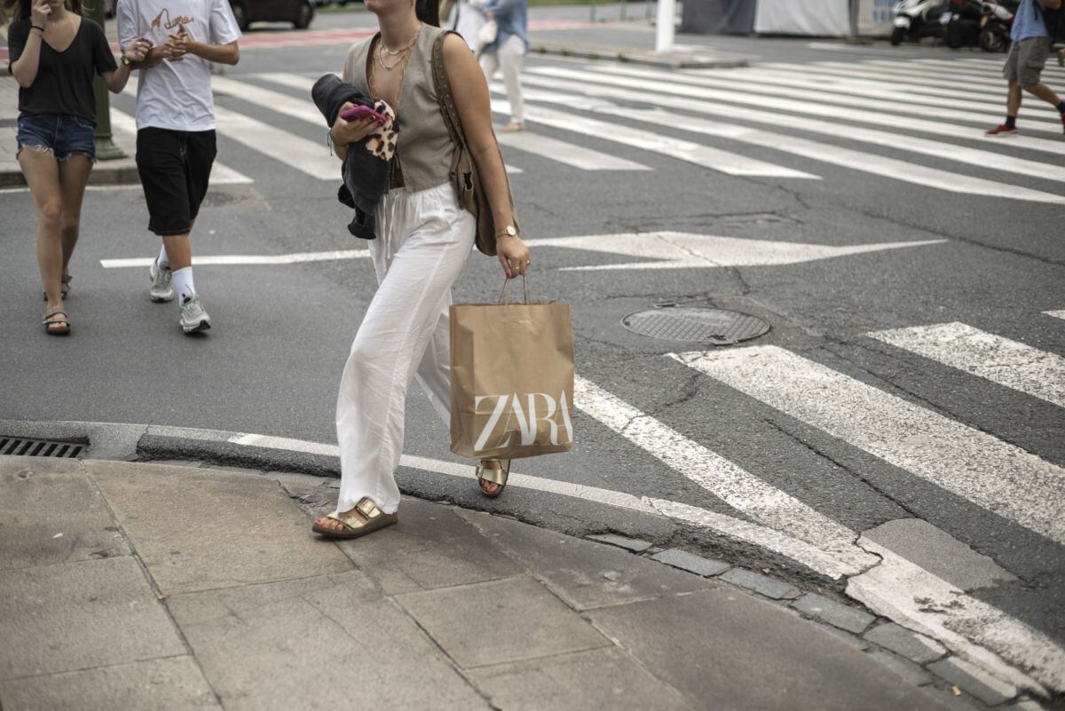 A shopper carries a Zara bag in A Coruna, Spain, on Wednesday, Sept. 6. 2023. Inditex SAs unfair discount and faster revenue growth could spur a further rally in the Zara-owners shares over the next 12 months, according to the stocks newest bull.