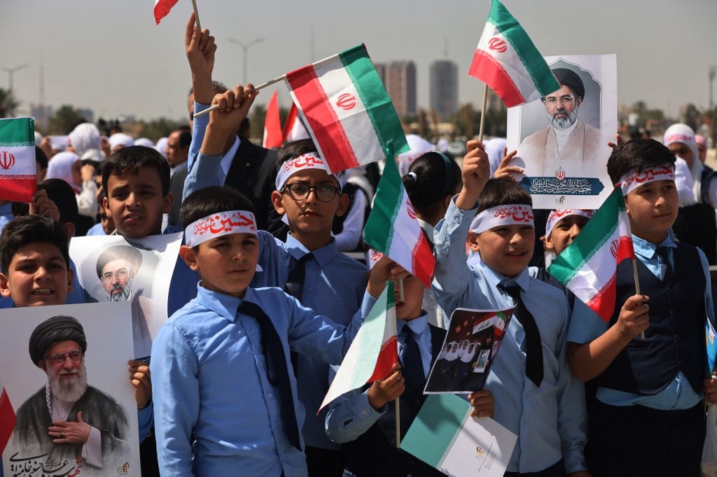 Iraqi schoolchildren hold portraits of Iran's supreme leader Ayatollah Mojtaba Khamenei (R) and Iran's slain supreme leader Ayatollah Ali Khamenei (L) during a anti-US and Israeli demonstration in Baghdad on on April 7, 2026. Iran said critical infrastructure, including two bridges, was struck April 7 by the United States and Israel, with US President Donald Trump warning "a whole civilisation will die" if a midnight deadline for a deal to open the Strait of Hormuz was not met. The strikes came as Iran's Revolutionary Guards warned they would deprive the United States and its allies of oil and gas if Washington crossed Tehran's "red lines". (Photo by AHMAD AL-RUBAYE / AFP)