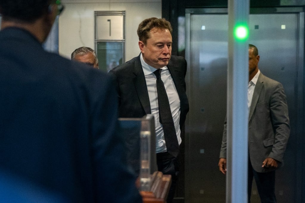 Elon Musk arrives at the federal courthouse as opening statements begin in the trial over Elon Musk's lawsuit against OpenAI in Oakland, California, on April 28, 2026. Opening remarks are set for April 28 in a courtroom showdown between billionaire Elon Musk and OpenAI over whether the artificial intelligence company betrayed its non-profit mission. The legal clash across the bay from San Francisco pits the world's richest person against a startup Musk once backed and now competes with in the booming AI sector. (Photo by Karl Mondon / AFP)