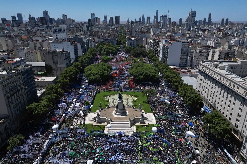 Aerial view of members of unions and social organizations taking part in a demonstration outside the Argentine Congress during a national strike against the government of Javier Milei in downtown Buenos Aires, on January 24, 2024. Argentine President Javier Milei faces the first national strike in just 45 days of government, against his draconian fiscal adjustment and his plan to reform more than a thousand laws and regulations that governed for decades. The largest Argentine union called the strike in rejection, in particular, of the changes by decree to the labor regime promoted by Milei, which limit the right to strike and affect the financing of unions. (Photo by Tomas CUESTA / AFP)