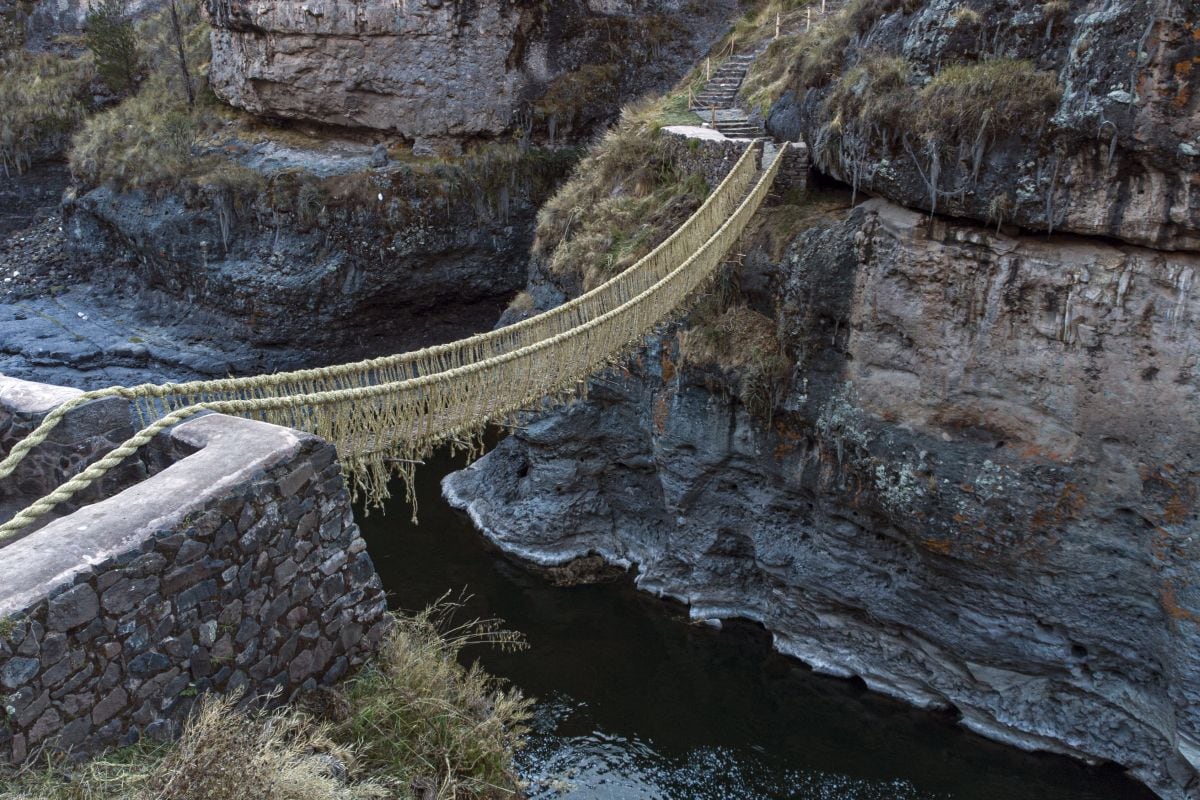 Aerial view of the Q'eswachaka rope bridge taken after its annual renovation, near Huinchiri, Quehue District, Cusco Department, in southern Peru, on June 11, 2023. The Q'eswachaka hand-woven straw bridge, which hangs over the Apurimac river, is rebuilt by local indigenous communities every June in a ritual that lasts three days. (Photo by Christian SIERRA / AFP)