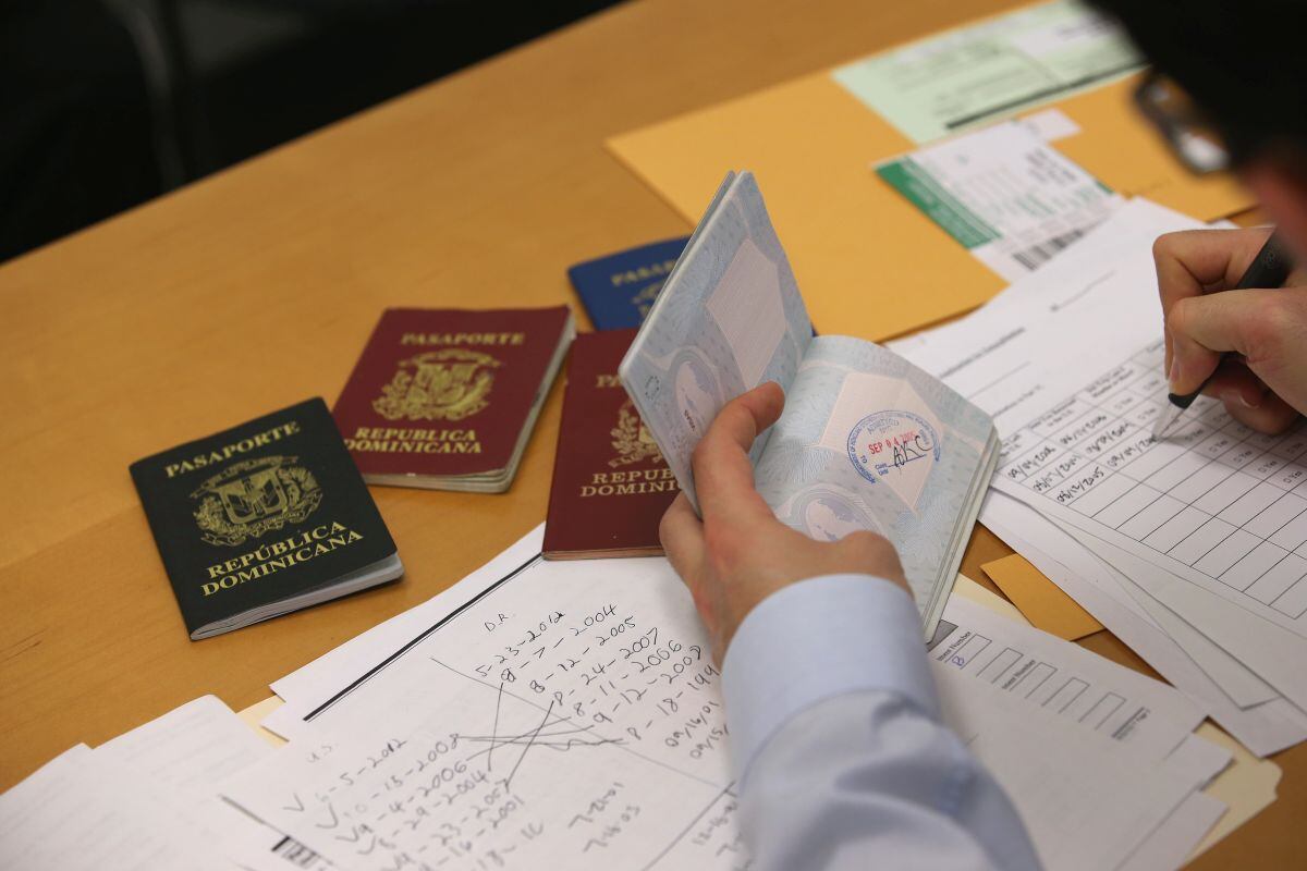 An immigration lawyer sorts through immigrant passports in New York.