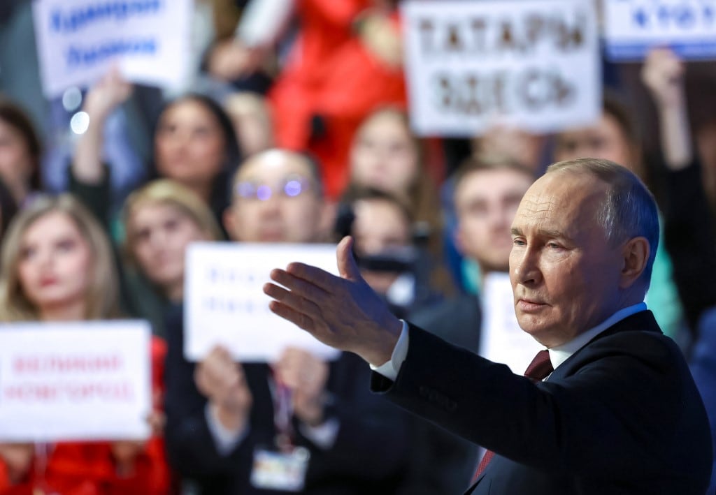 In this pool photograph distributed by the Russian state agency Sputnik, Russia's President Vladimir Putin holds his annual end-of-year press conference in Moscow on December 19, 2025. (Photo by Alexander KAZAKOV / POOL / AFP)