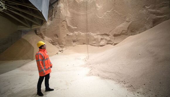 An employee looks at soybean meal produced by Glencore Plc as it is stored before transportation in a grain flat storage at the European Bulk Services (E.B.S.) terminal at the Port of Rotterdam in Rotterdam, Netherlands, on Tuesday, April 25, 2017. Since taking over Glencore Agriculture in 2002, Chris Mahoney has overseen the transformation of the unit into a standalone enterprise that generates more revenue from owning fixed assets in strategic locations than simply trading.
