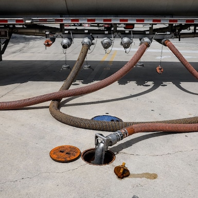 A fuel tanker delivers fuel to a gas station in the US.