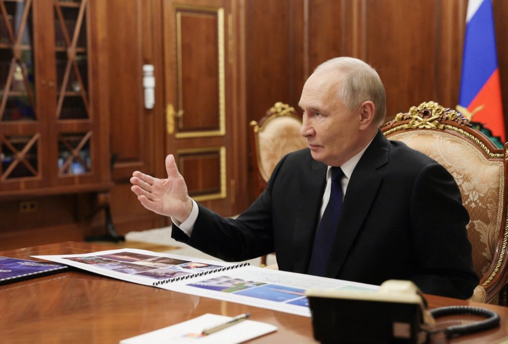 In this pool photograph distributed by the Russian state agency Sputnik, Russia's President Vladimir Putin attends a meeting with Deputy Defence Minister and Chair of Defenders of the Fatherland Foundation in Moscow on December 30, 2025. (Photo by Mikhail METZEL / POOL / AFP)