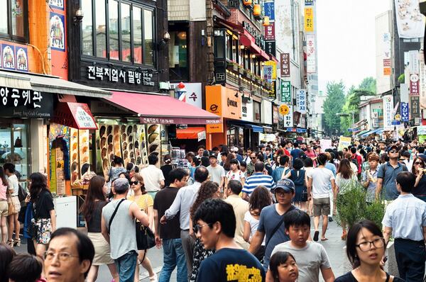 Seoul, South Korea - August 17, 2013: Tourists and shoppers line the sidestreets of Insadong in Seoul, South Korea. Insadong is a popular tourist destination in Seoul that offers a variety of traditional crafts and goods, along with the usual souvenirs.