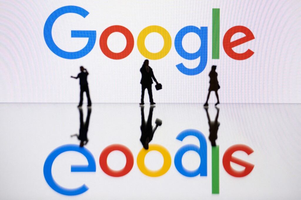 (FILES) This illustration photograph taken on October 30, 2023, in Mulhouse, eastern France, shows figurines next to a screen displaying a logo of Google, a US multinational technology company. Google on October 14 said it would invest $15 billion in India over the next five years as it announced a giant data centre and artificial intelligence base in the country's south. (Photo by SEBASTIEN BOZON / AFP)