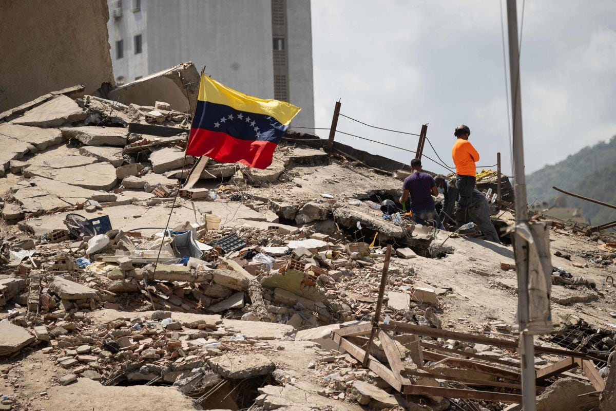 Voluntarios realizan labores de búsqueda en los escombros de un edificio este lunes, en La Guaira (Venezuela). Foto: EFE/ Ronald Peña R