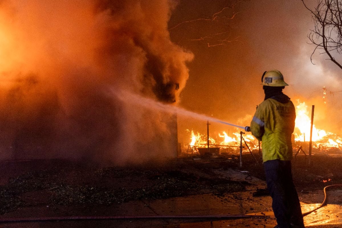 A firefighter battles the Eaton Fire in Altadena, California, US, on Wednesday, Jan. 8, 2025. The most destructive wind storm to strike the Los Angeles area in 14 years is fanning wildfires and has sent thousands of residents fleeing for their lives, with dangerous gusts expected to persist for at least another two days. Photographer: Jill Connelly/Bloomberg