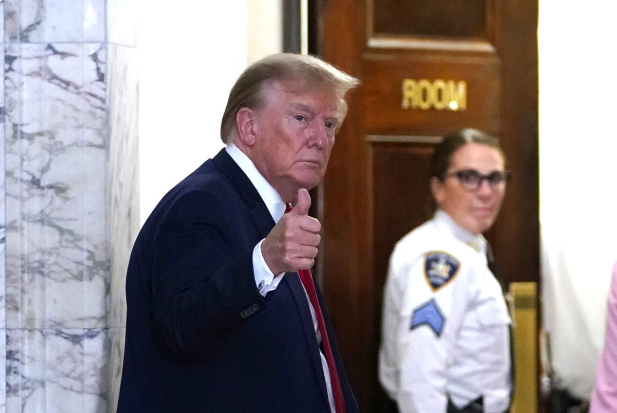 (FILES) Former US President Donald Trump gestures as he returns from a break at the New York State Supreme Court during the civil fraud trial against the Trump Organization, in New York City on December 7, 2023. A US court on August 21, 2025, threw out a $464 million civil penalty against President Donald Trump imposed by a judge who found he fraudulently inflated his personal worth, calling the sum "excessive" but upholding the judgment against him. "The court's disgorgement order, which directs that defendants pay nearly half a billion dollars to the State of New York, is an excessive fine that violates the Eighth Amendment of the United States Constitution," said the Appellate Division of the New York Supreme Court. (Photo by TIMOTHY A. CLARY / AFP)