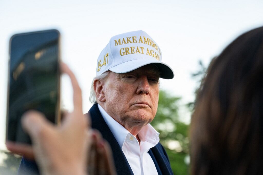 US President Donald Trump speaks to the press after arriving on the South Lawn of the White House in Washington, DC, on April 27, 2025. Trump is returning to Washington after attending the funeral of Pope Francis and spending part of the weekend at his Bedminster resort. (Photo by Annabelle GORDON / AFP)