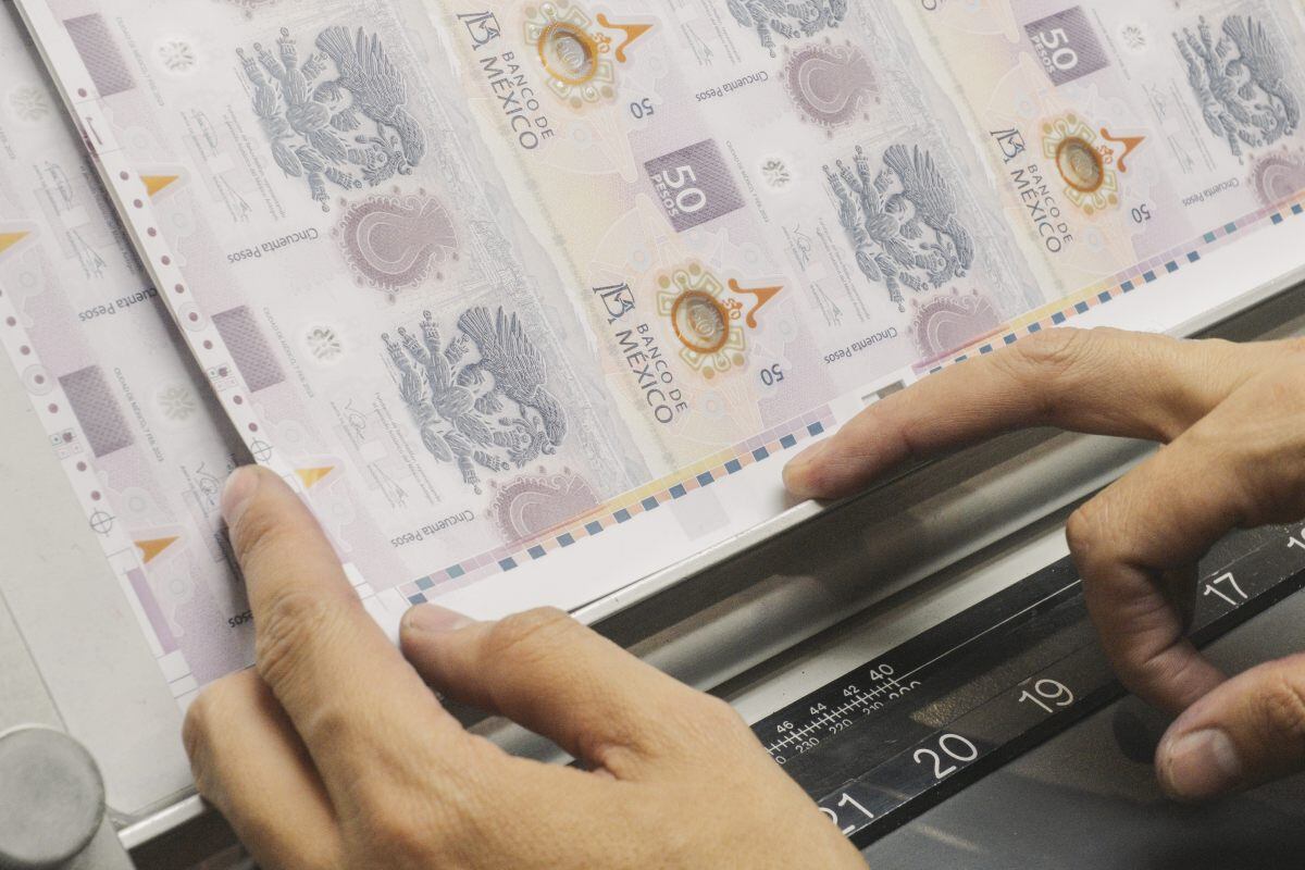 A worker inspects a sheet of Mexican 50 peso banknotes at the Bank of Mexico (Banxico) printing facility in Mexico City, Mexico, on Friday, Oct. 6, 2023. Mexico's peso is the second worst performing major currency in the world Thursday, lagging only the South African rand, as market makers report systematic unwinding of bullish positions since the currency breached of its 200-day moving average.