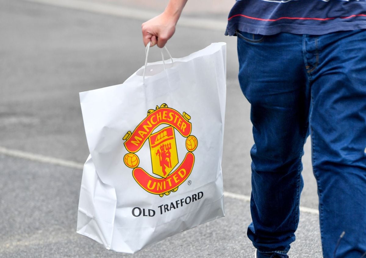 A customer leaves after shopping at the Megastore at Old Trafford football ground, home of Manchester United Football Club, in Manchester, UK, on Friday, Aug. 19, 2022. Manchester United FCs owners are considering opening up the iconic English football club to a new investor -- with private equity firms likely to be crowding the field alongside high-net worth individuals. Photographer: Anthony Devlin/Bloomberg