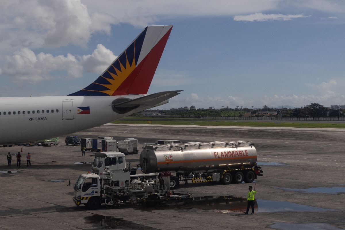 A jet fuel tanker near a Philippine Airlines jet at Ninoy Aquino International Airport in Manila.