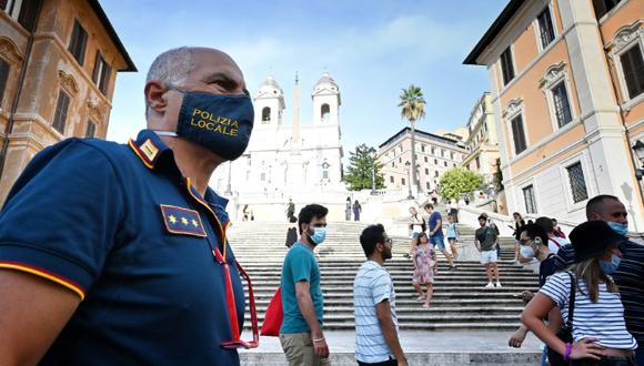 La policía italiana vigila que los transeúntes lleven mascarillas de protección, en Roma el 17 de agosto de 2020. La prensa italiana se hace eco de numerosos testimonios de jóvenes contagiados durante sus vacaciones. (Foto: AFP)