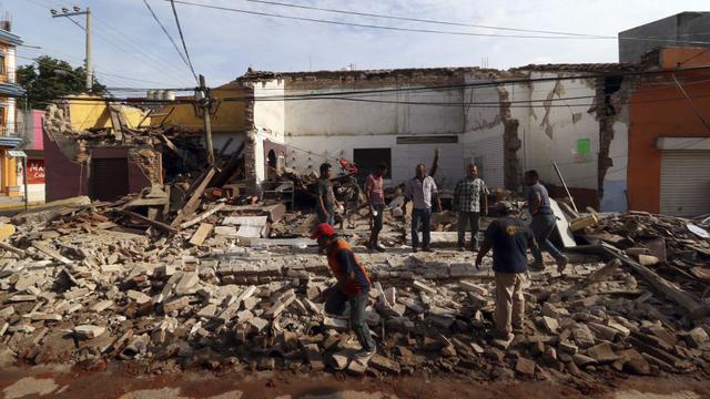 Foto 18 | Los residentes se colocan en los escombros de un edificio parcialmente derrumbado derribado por el terremoto en Juchitan, Estado de Oaxaca, México. (Foto: AP)